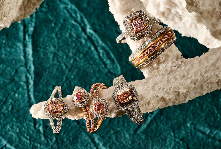 Pink diamond rings sitting on coral