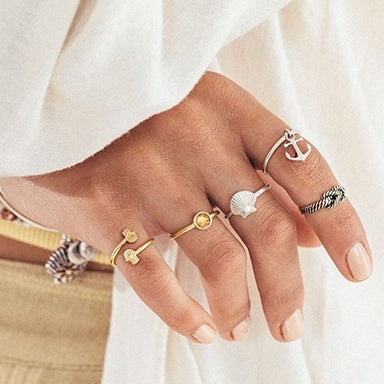 Woman wearing ALEX AND ANI rings on each finger