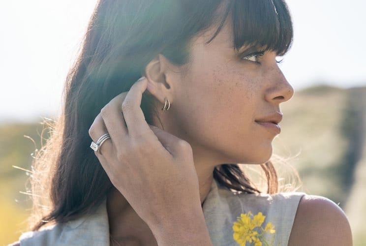 Woman wearing Tacori rings and earrings