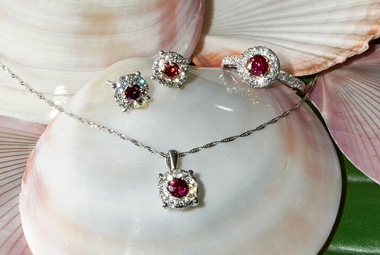 Purple diamond rings and necklaces sitting on shells
