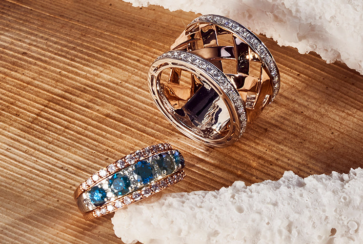 Two ladies' rings resting on driftwood